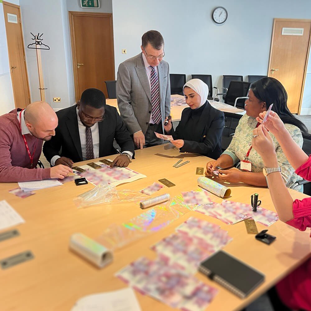 a diverse group of people analysing bank notes in a board room
