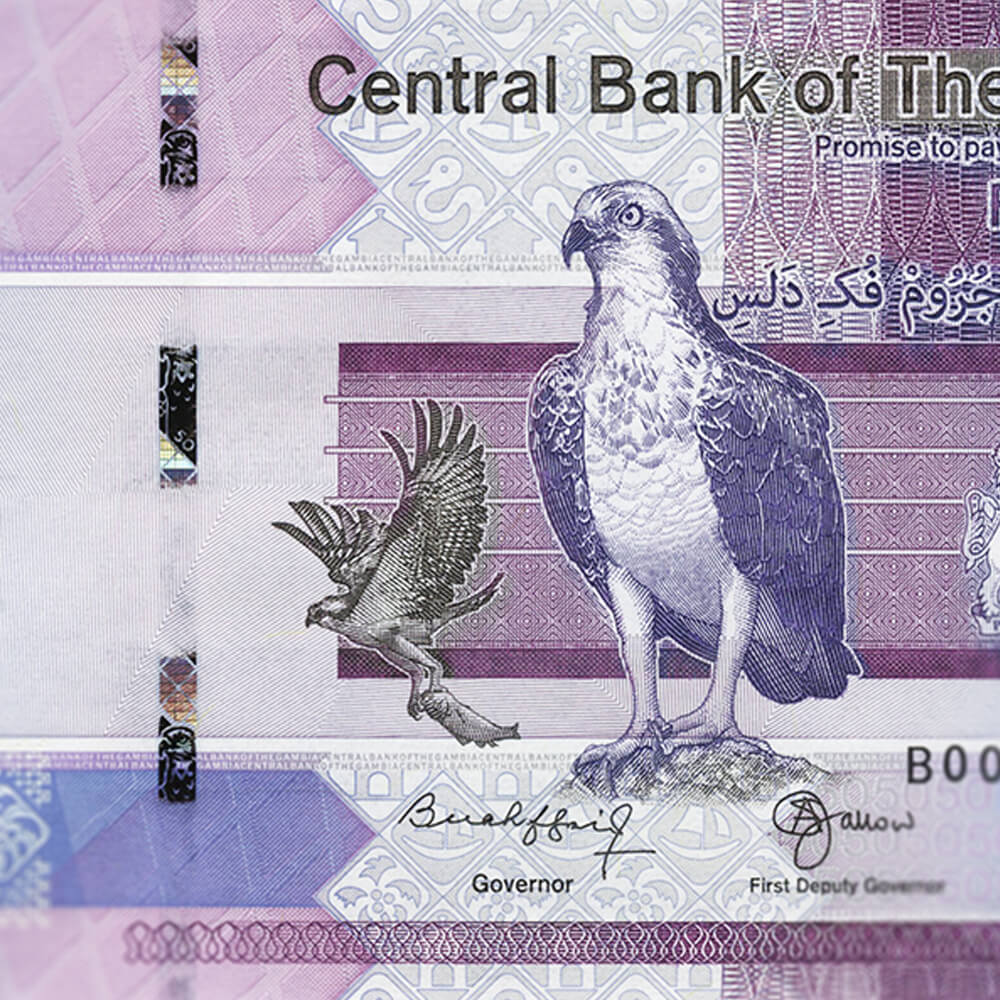 a highly intricate purple and blue bank note featuring an etching of a bird of prey