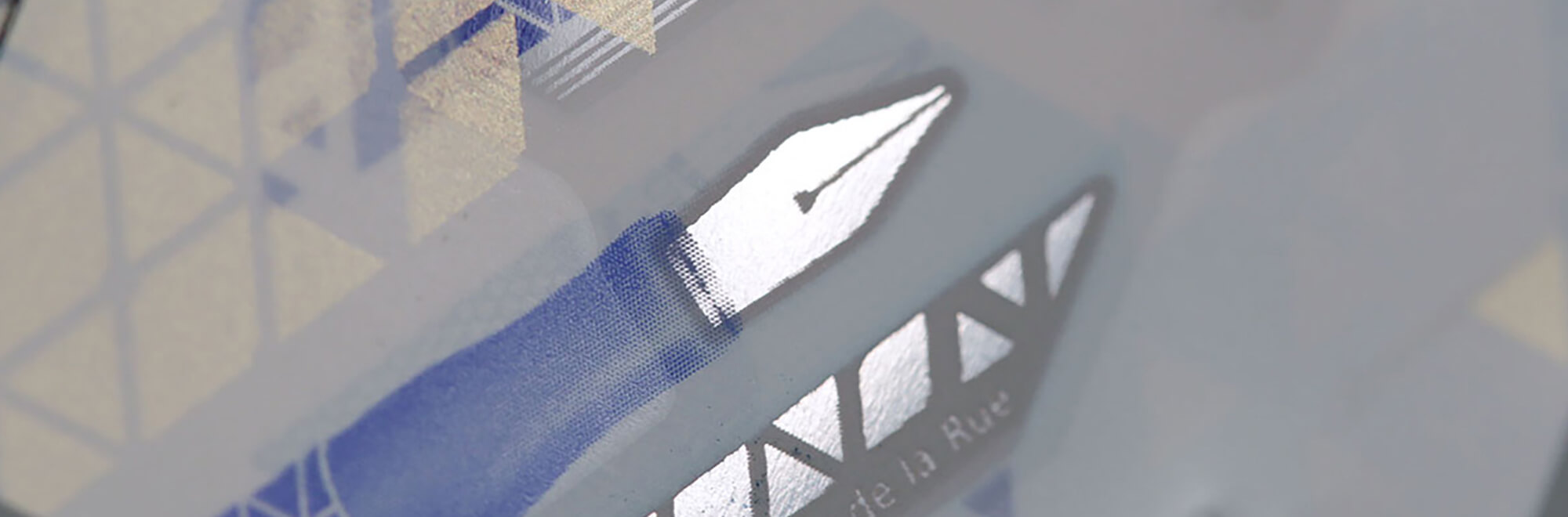 an intricate etching of a traditional purple fountain pen on a house bank note