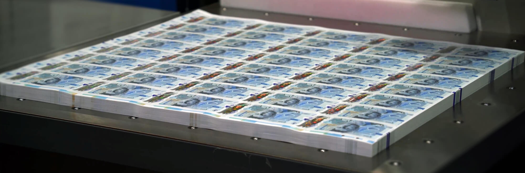 a stack of bank notes hot off the press